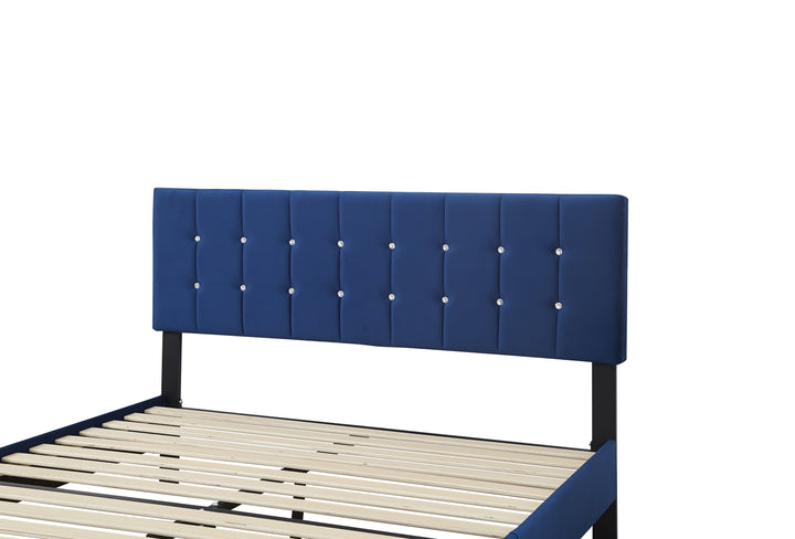 close up view of a royal blue slated bed base with faux diamond buttons on the headboard