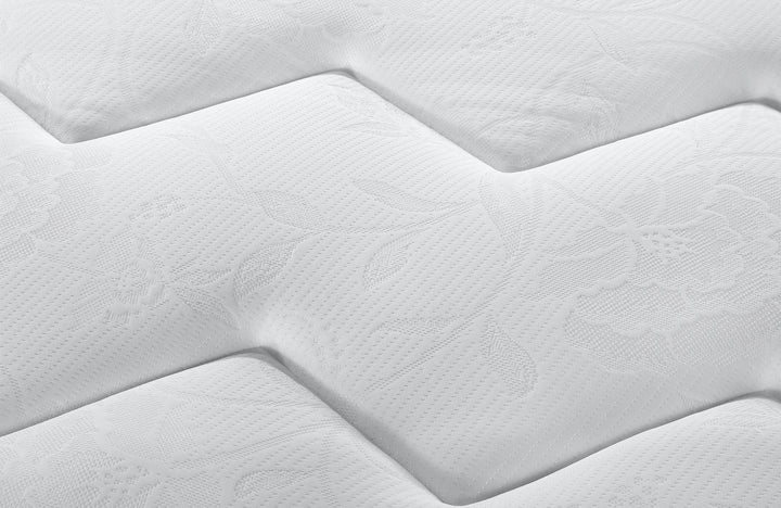 close up view of zig-zag pattern on the fabric of the grey and white detachable mattress cover