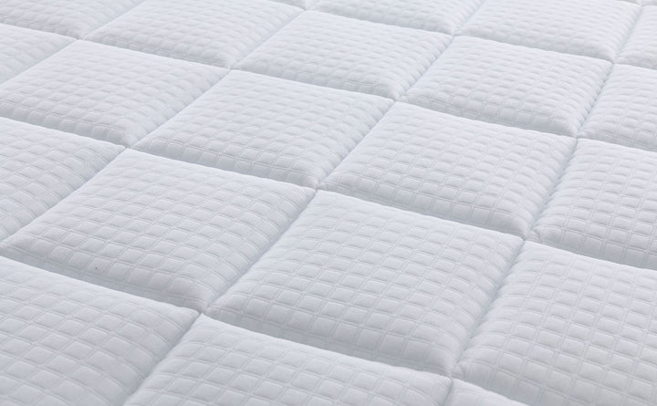 close up view of the breathable top knit fabric of the Quincy mattress from Rainbow Home 