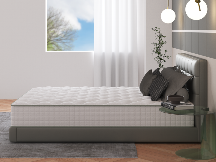 bedroom with side angle of the Zina memory foam pocket spring mattress from Rainbow Home on a grey bed base