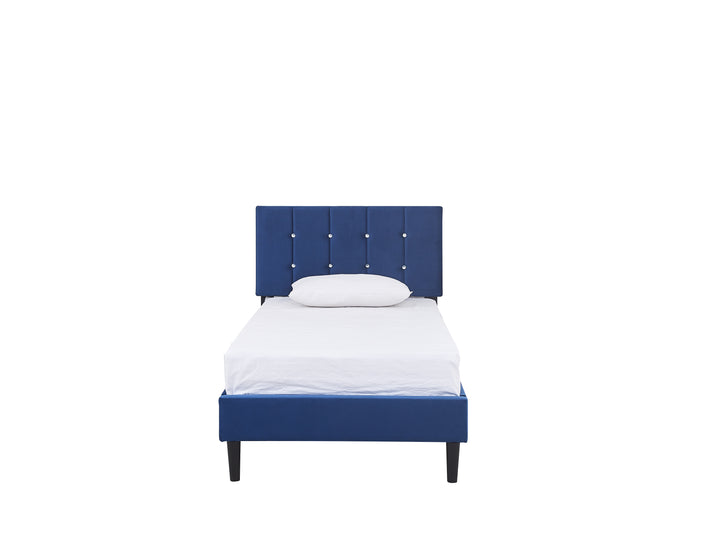 front view of a white mattress and pillows on a royal blue velvet upholstered bed base with a headboard decorated with faux diamond buttons